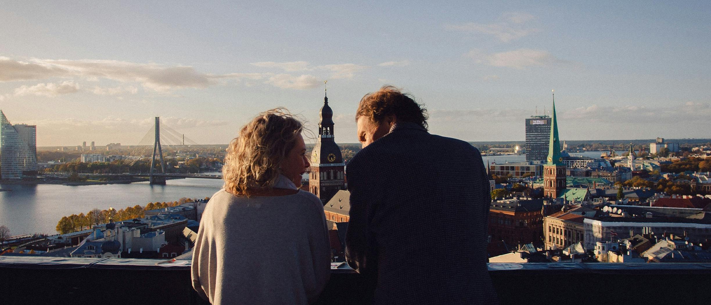 A couple looking at the old town of Riga